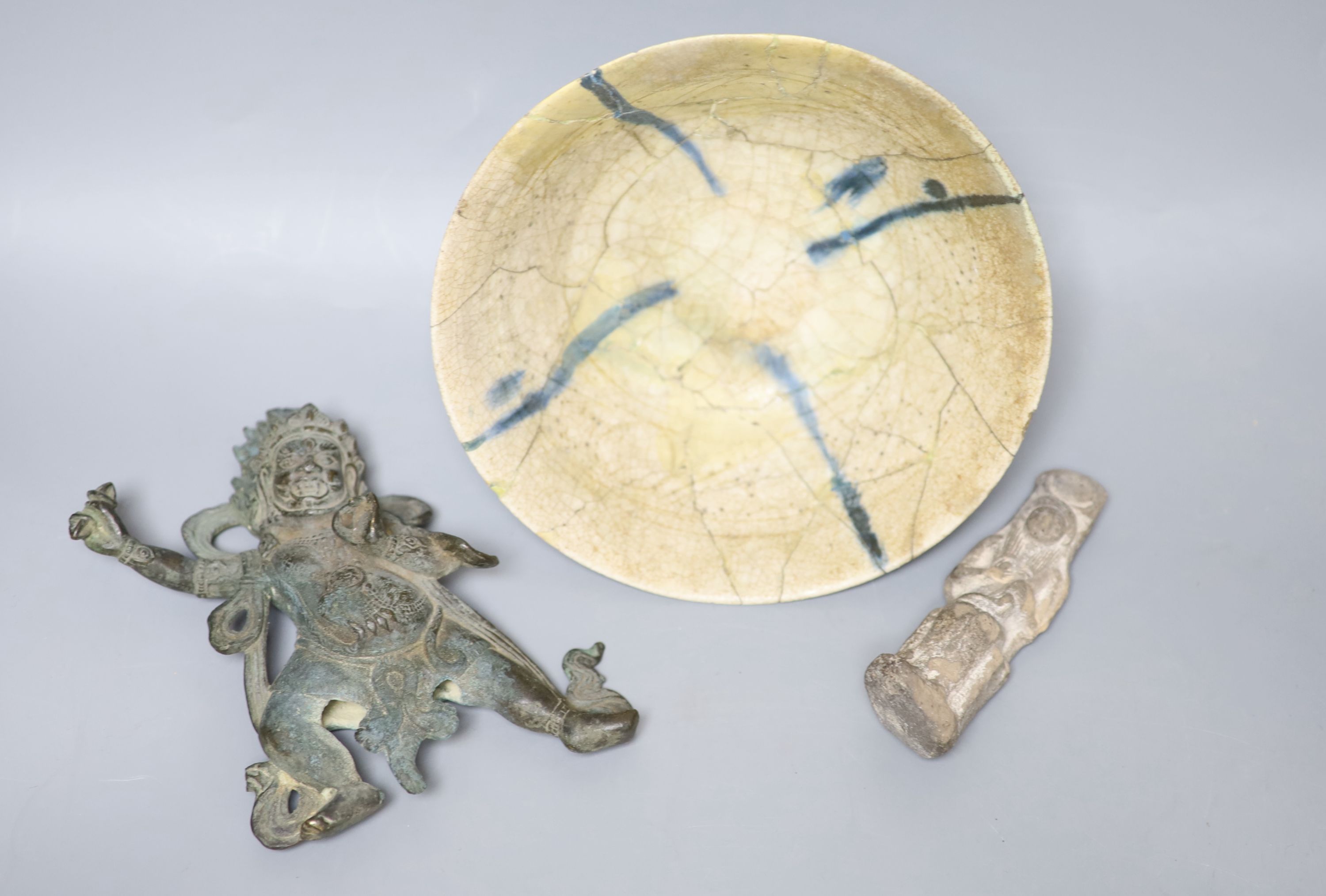 An Egyptian style stone carving, a Tibetan bronze of a deity and a Persian bowl, diameter 19cm